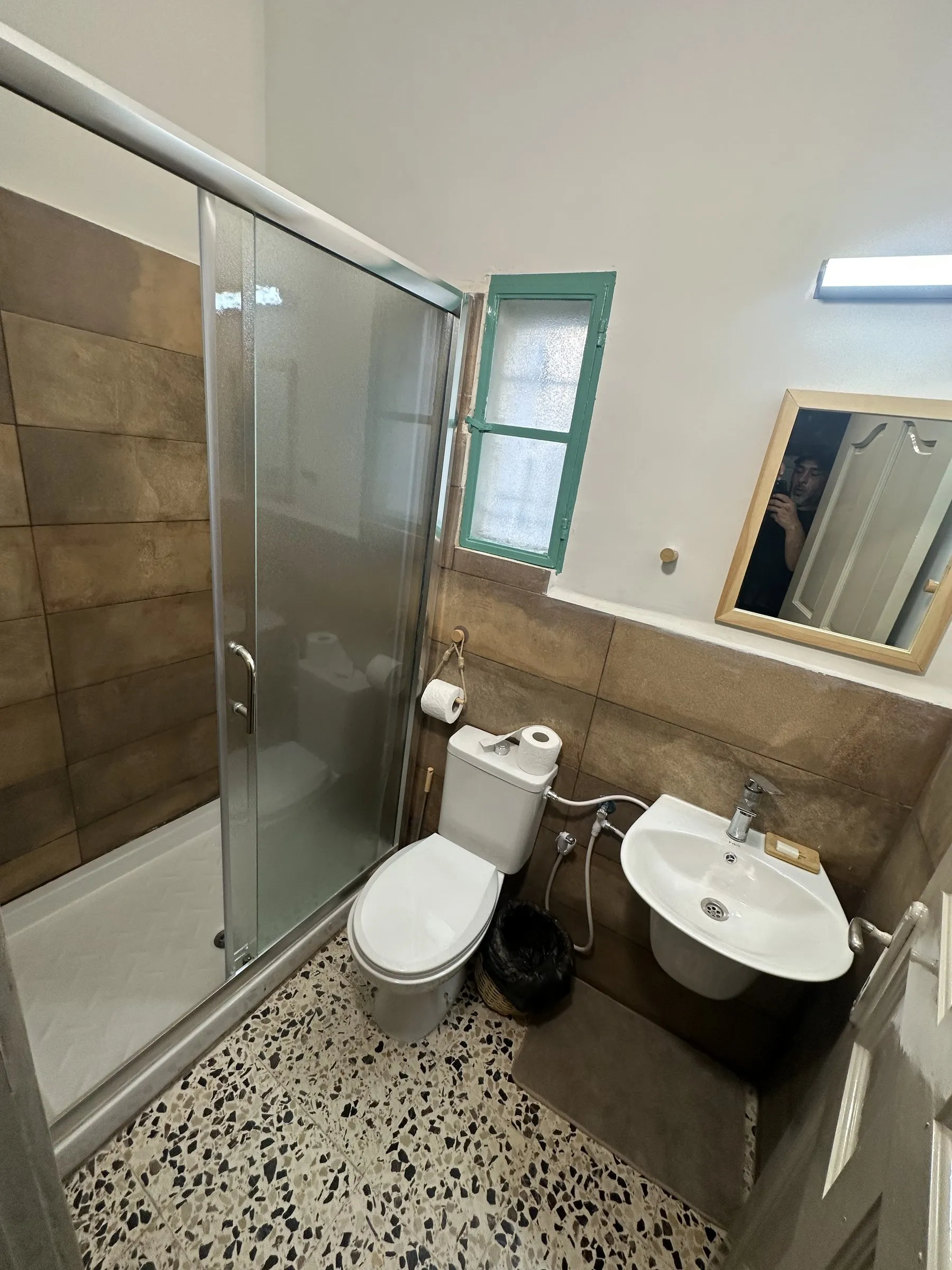 The shared room’s own bathroom with glass shower